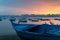 Turquoise blue fishing boat on the beach at sunrise with Alexandria skyline in far distance