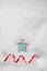 Turquoise Blue Star and Red Swirling Ribbon on Snow