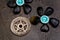 Turquoise candles with black rocks and silver pentagram on gray