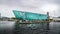 The turquoise colored Maritime Museum `Nemo` in the harbor of the city of Amsterdam
