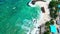 The turquoise colored sea water that keep splashing over the rocks at a beach