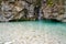 Turquoise colored water of Pisnica river and small waterfall, Triglav National Park, Slovenia, travel background