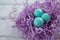 Turquoise Easter eggs in the violet nest