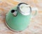 Turquoise electric tea kettle on wooden table