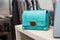 Turquoise female handbag with precious stones in the store.