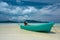 Turquoise fisherman boat on the beach