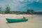 Turquoise fisherman boat on the beach