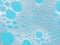 Turquoise froth, foamy background, soap, detergent bubbles on water.