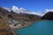 Turquoise Gokyo lake, village and mount Cholatse