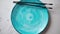 Turquoise hand painted ceramic serving plate with wooden chopsticks on side