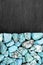 Turquoise heap stones texture on half black stone background. Place for text