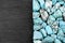 Turquoise heap texture on half black stone background. Place for text