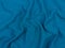 Turquoise jersey fabric matte texture top view. Blue knitwear background. Fashion color trendy clothes. Website backdrop