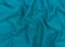 Turquoise jersey fabric matte texture top view. Blue knitwear background. Fashion color trendy clothes. Website backdrop