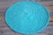 Turquoise knitted round carpet or rug.