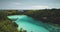 Turquoise lake with resting people aerial view. Tourists swimming at azure crystal clean lagoon