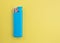 A turquoise lighter on a bright colored background with copy space. Smoking concept