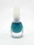 Turquoise nail polish with brush inside in the bottle