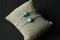 Turquoise nugget two bracelets on a silver chain, on a black modern background. Bracelet made of stones on hand from natural stone