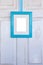 Turquoise Picture Frame Hanging on Distressed White Door