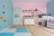 Turquoise and pink children playroom with climbing wall