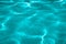 Turquoise Pure clear water in the sea, sun glare, waves and sea sand. Calm sea water background