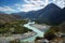 Turquoise river, mountains and skies