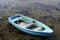 Turquoise rowing boat shallow clear sea water