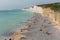 Turquoise sea Birling gap beach and Seven Sisters white cliffs with people