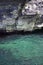 Turquoise sea and rocky cliff. vertical photo