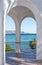 Turquoise sea, viewed through white painted arches. Nerja, Spain.