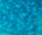 Turquoise sequins, blurred abstract background
