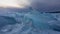 Turquoise shiny ice hummocks on a frozen lake