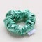 Turquoise silk Scrunchy isolated on white background. Hairdressing tool of Colorful Elastic Hair Band, Bobble Scrunchie