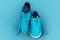 Turquoise sneakers on a turquoise sports mat.