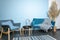 Turquoise sofa and chair, classic living room decoration, blue wall, carpet on dark wooden floor, interior style