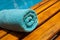 Turquoise towel on a lounger by the blue pool