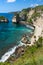 Turquoise tropical bay surrounded by cliffs