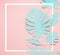 Turquoise tropical leaves layout. White frame at paper tropical leaves on pink background. Creative composing in pastel color with