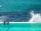 Turquoise water pool next to the ocean with a giant wave at Bondi Beach in Sydney