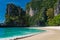 Turquoise water and sandy beach, high cliffs