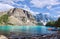 Turquoise waters of beautiful Moraine lake. Snow-covered Rocky mountains in summer day. Canoes on a jetty.