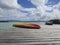 Turquoise waters of the Caribbean Sea and small jetty with canoe, orange kayak. Tropical sky. Idyllic tropical landscape