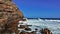 Turquoise waves beat against the cliffs of the Cape of Good Hope.