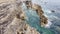 Turquoise waves break on a rock. Beautiful seascape. White sea foam