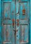 Turquoise wooden door with peeling paint
