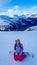 Turrach - A girl sitting on the snow with her snowboard