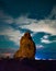 Turret arch at night with clouds and stars in Arches National Park