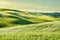 Tuscan landscape, with green grass and rolling hills