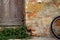 Tuscan scene with brick, wood door, plant and bicycle